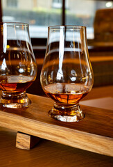 Flight of single malt scotch whisky in glasses served in whiskey bar in Edinburgh, UK