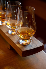 Flight of single malt scotch whisky in glasses served in whiskey bar in Edinburgh, UK