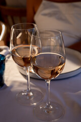 Dinner at sunset in French restaurant with cold dry rose wine in Port Grimaud, summer vacation on French Riviera, France