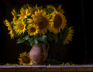 beautiful yellow Sunflower still life bouquet  in a clay jug ceramic rustic style oil honey Dark photo background wooden table Vintage. Retro. low key Autumn flowers.
