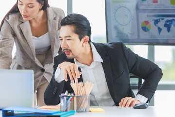 Millennial Asian cheerful happy professional successful male businessman and female businesswoman colleague in formal suit smiling brainstorming discussing talking in company office meeting room.