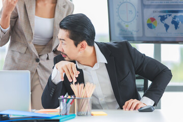 Millennial Asian cheerful happy professional successful male businessman and female businesswoman colleague in formal suit smiling brainstorming discussing talking in company office meeting room.