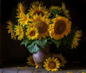 beautiful yellow Sunflower still life bouquet  in a clay jug ceramic rustic style oil honey Dark photo background wooden table Vintage. Retro. low key Autumn flowers.