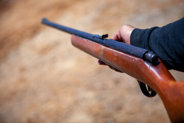 close up of hand holding old gun rifle hunting weapon arms shotgun - obrazy, fototapety, plakaty