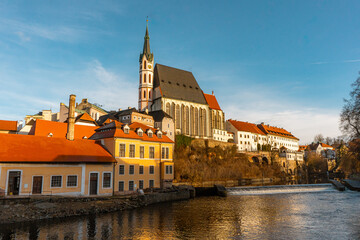 Naklejka premium Beautiful view and Church of St.Vitus along Vltava River in Cesky Krumlov , medieval and romantic town during winter. Cesky Krumlov , Czech : December 15, 2019