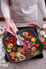 Grilled vegetables on grill pan at domestic kitchen