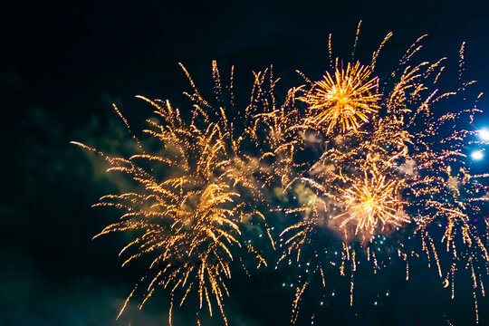 Fireworks above a street lamp, against the background of the night sky.