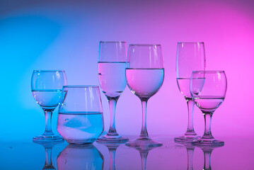 Wine glasses with neon multicolor light