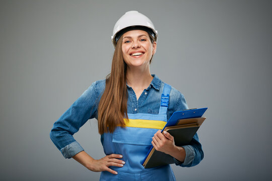 Isolayed portrait of woman builder holding books.