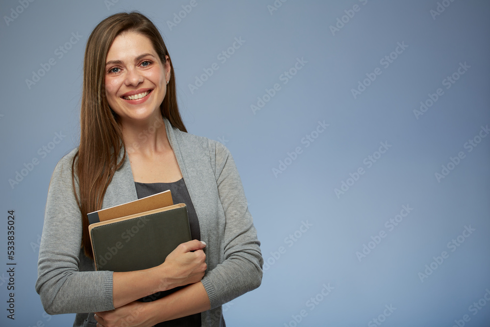 Poster Smiling young woman teacher or student girl holding books. isolated female portrait.