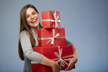 Smiling woman holding stack of presents. Isolated female portrait.