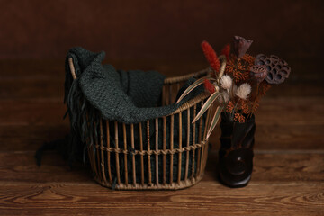 Newborn photography digital background prop. Wooden basket with autumn flowers on a wooden...