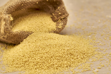 croup couscous poured out of a canvas bag on the table
