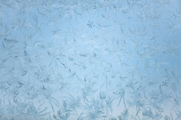 winter ice pattern on the window, a beautiful natural pattern on glass in the cold season, selective focus