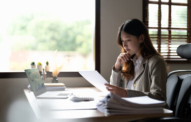 Accountant woman hand press on calculator for make financial report or company's profit monthly at...