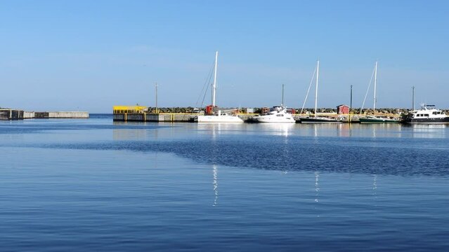 Some small vessels remain nestled in a protected bay on a sunny morning.