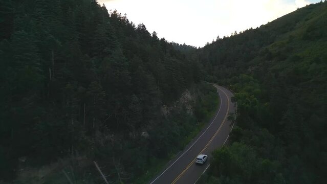 Traffic on Countryside Road in Rural New Mexico USA. Aerial View of Cars and Conifer Forest of Sandia Mountains, Drone Shot