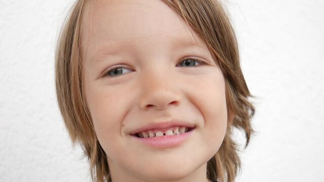 A portrait of a cute smiling boy or girl with jagged teeth