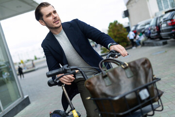 Fototapeta na wymiar young male businessman rides a bicycle to work, Concept of environmental care, safe mode of transport