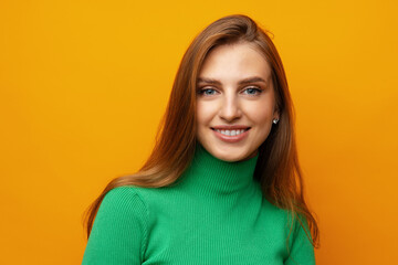 Fototapeta premium Pretty young woman smiling over yellow isolated background