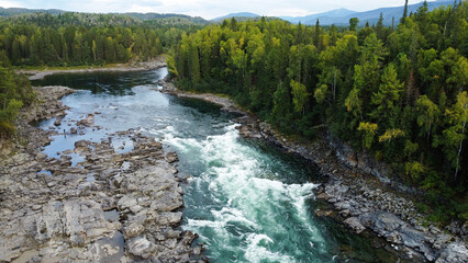 Wild nature landscape drone view with river and forest. Fog above water. Mountain Siberian river flow, water on stones,  forest  trees. aero view.