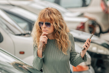 woman buying used or second-hand car at dealership