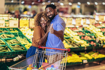 African american couple shopping for healthy fresh food at produce section of supermarket.