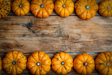 Pumpkins on a wooden rustic background. Yellow autumn harvest pumpkins on the festive table. Fall holidays, halloween, thanksgiving day, food concept.
