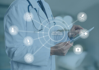 Doctor with modern tablet against blurred background, closeup. Concept of antibiotic resistance