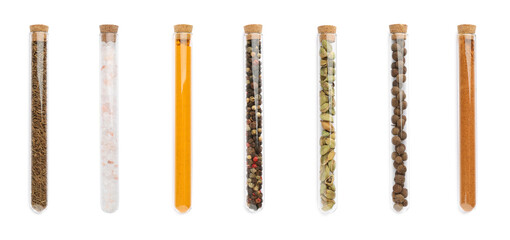 Set of glass tubes with different spices on white background, top view. Banner design