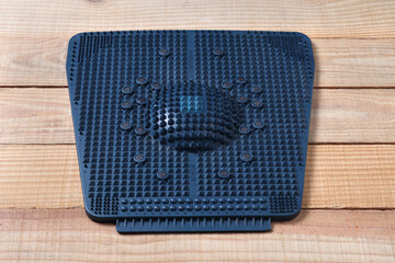 acupressure mat on a wooden base