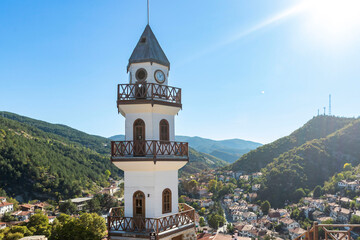 Fototapeta premium The Victory Clock Tower (Saat Kulesi, Zafer Kulesi) with the traditional houses in the background. Goynuk, Bolu, Turkey. 