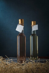 set of two 250 ml bottles of white and pink wine with blank labels. Wooden shavings below. Wines...
