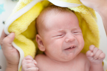 Sweet and cute small little newborn baby is hungry and upset and cry strongly inviting her parents...