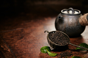 Dried tea near old teapot