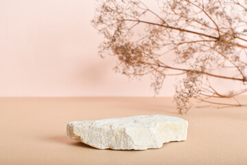 Stone podiums with dried flowers on a beige background. Abstract eco-podium for organic products