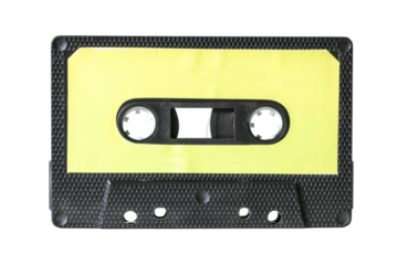 An old vintage cassette tape from the 1980s (obsolete music technology). Black hexagon grid plastic body, pale yellow empty label, isolated.
