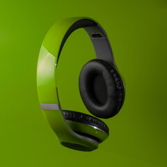Green headphones on a green background. Concept music.