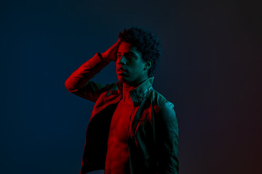 Portrait of young stylish man in neon red