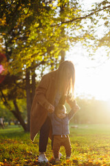 mother and son in the park first steps
