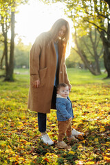 mother and son in the park first steps