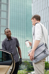 Taxi Driver Opening Door for Passenger