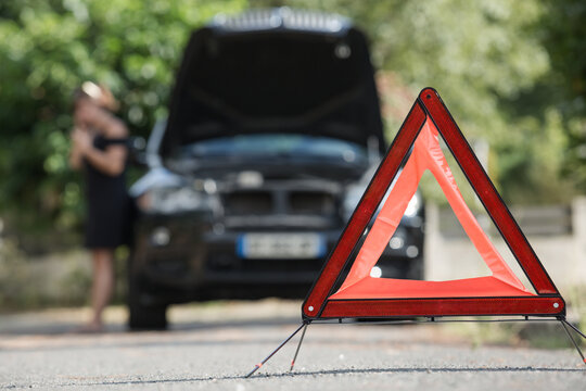 Red Warning Triangle With A Broken Down Car