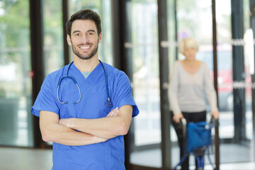 portrait of male doctor in blue scrubs