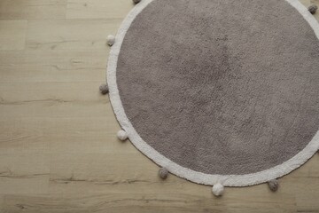 Obraz na płótnie Canvas Stylish soft rug on floor, above view. Space for text