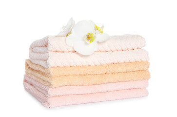 Obraz na płótnie Canvas Stack of clean soft towels with orchids isolated on white