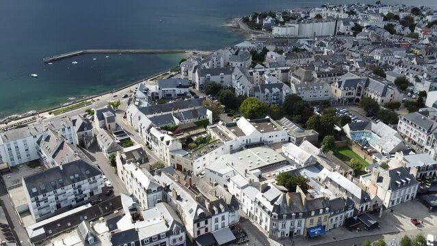 the small town of concarneau with a harbor in brittany (france), drone shot in bright weather with clouds on the horizon