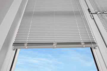 Fototapeta premium Stylish window with horizontal blinds, low angle view