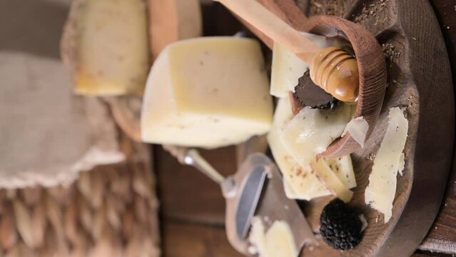 Pecorino cheese with truffle, traditional Italian sheep's milk cheese with truffle. A typical product of the dairy regions of Tuscany and Sardinia. Honey and cheese. video vertical