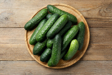 Fresh ripe cucumbers on wooden table, top view